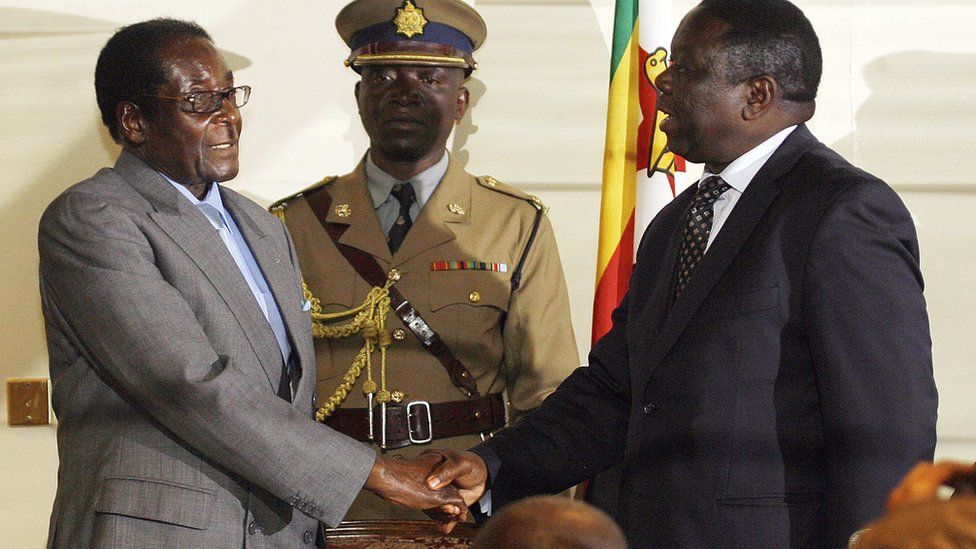 Mr Mugabe shakes hands with Mr Tsvangirai after a power-sharing agreement in 2008