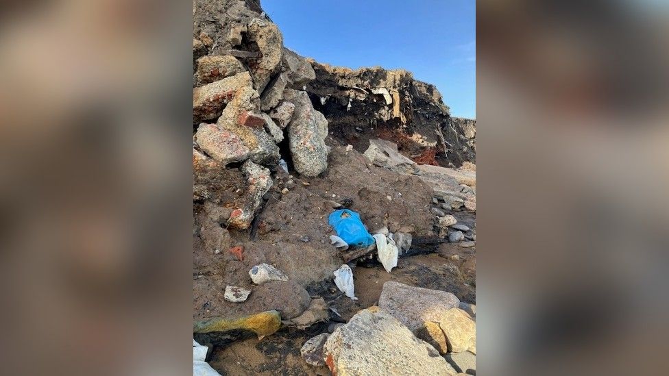 Plastics and debris embedded in the cliffside