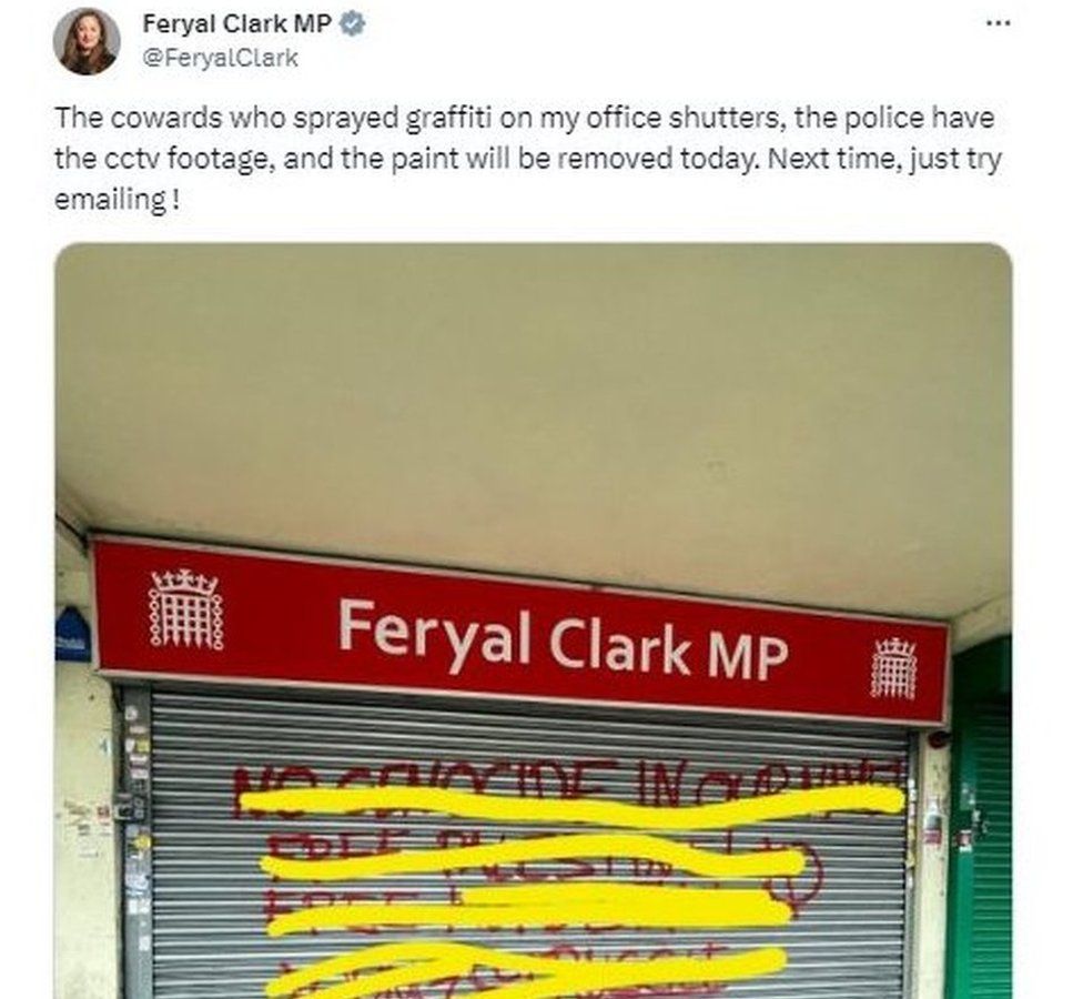 A post from Feryal Clark showing red graffiti on the metal shutters of her constituency office