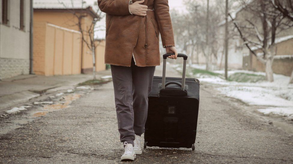 A person with a suitcase