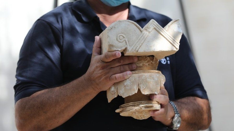 Israeli archaeologist Yaakov Billing displays a stone capital from a palace from the era of a Biblical Jewish kingdom in Jerusalem (3 September 2020)