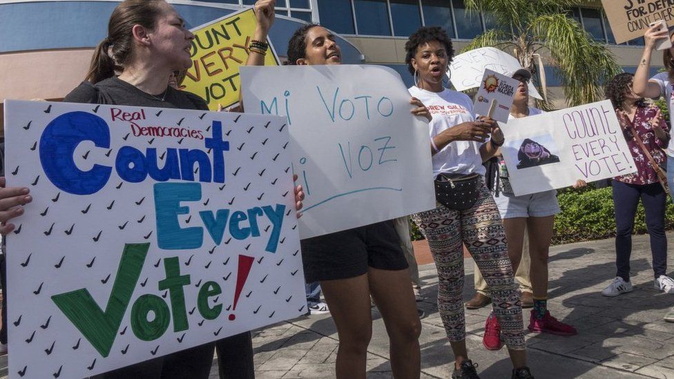 A crowd protests to demand a vote recount in Miami, Florida
