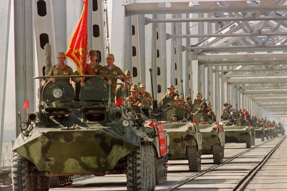 A convoy of Soviet Army armoured personal vehicles cross a bridge in Termez, Afghanistan, 21 May 1988.