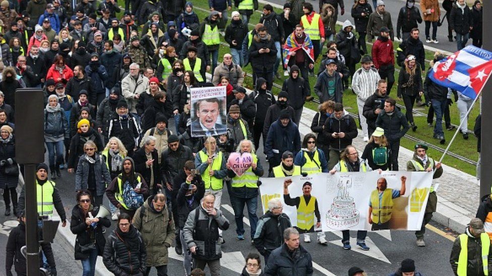 Yellow vest protesters march in Paris on November 16, 2019, to celebrate the first anniversary of the movement