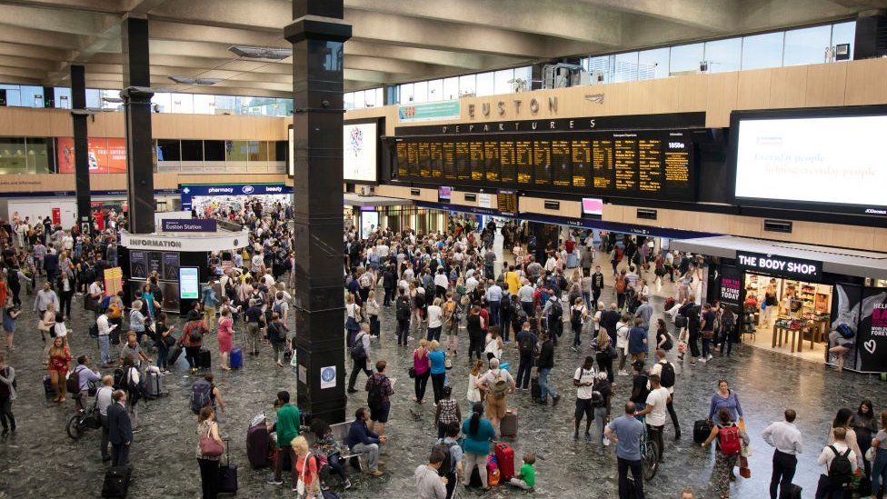 Interior view of the main concourse full of commuters and people travelling from Euston Railway Station in London in July 2018.