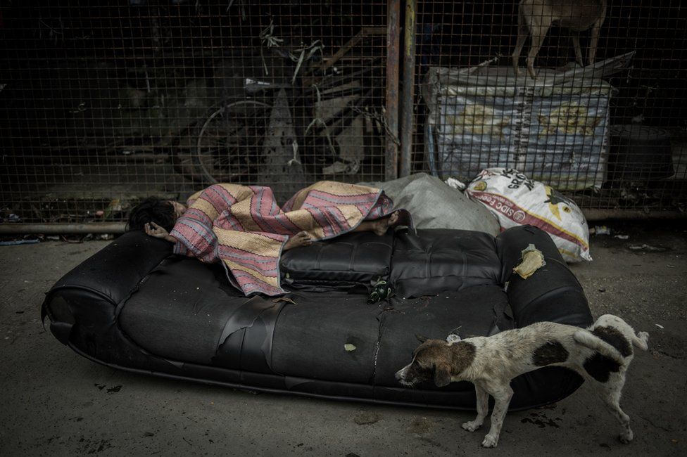 A girl sleeping on the side of the street in Parola Tondo Area, Manila City