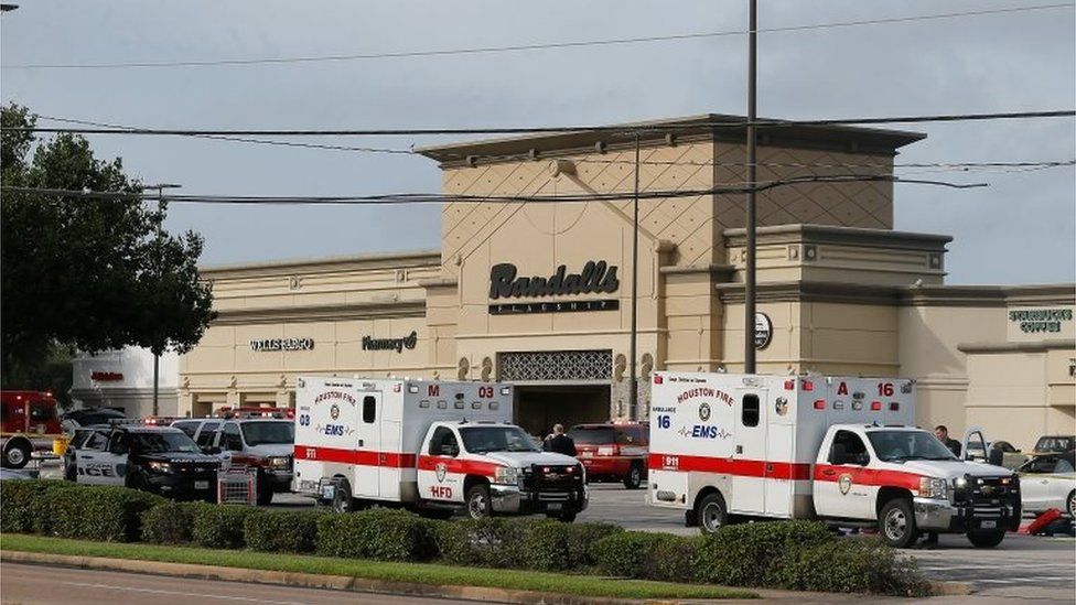 Ambulance crews on standby after a gunman went on a shooting rampage wounding nine before he was shot and killed by police in Houston, Texas.