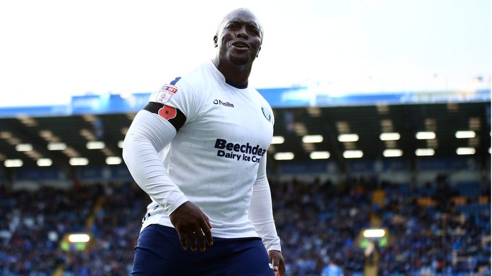 Adebayo Akinfenwa of Wycombe Wanderers standing on the pitch at Fratton Park