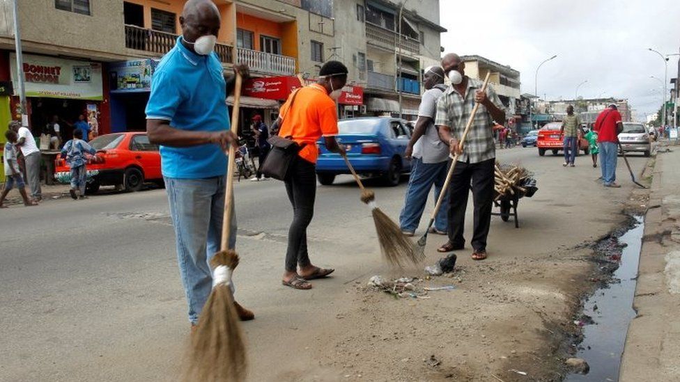 Volunteers clean a street of Treichville during the world clean up day in Abidjan, Ivory Coast September 15, 2018.