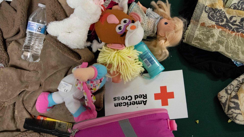 Children's dolls and supplies lay on a cot at a Hurricane Florence evacuation shelter