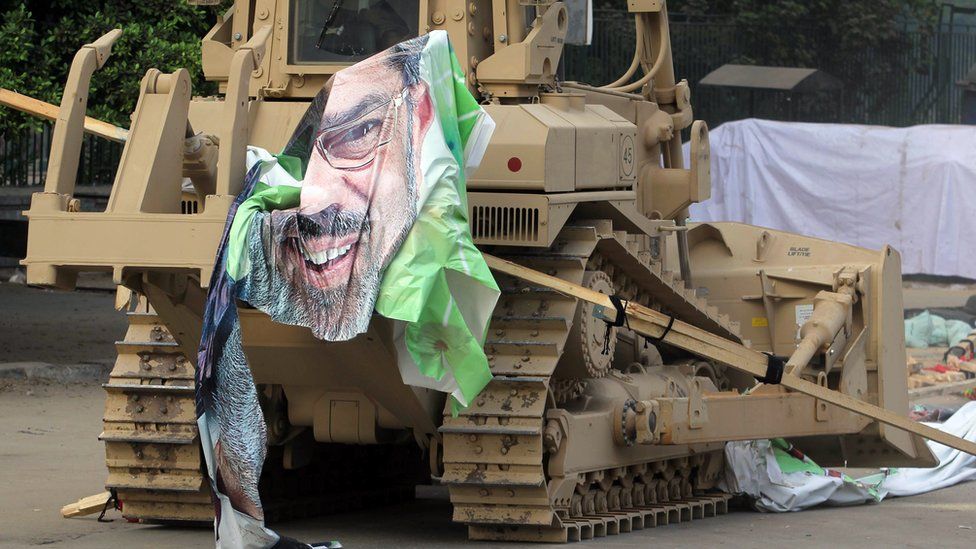 An Egyptian military bulldozer dismantles the pro-Morsi sit-in at Cairo's al-Nahda Square on 14 August 2013
