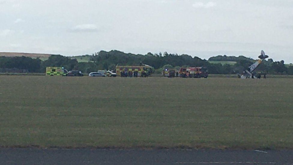 Emergency service vehicles at site of plane accident in Duxford