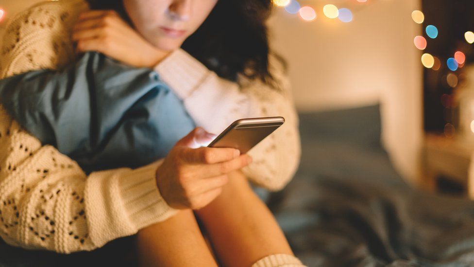 Young girl looking at her phone