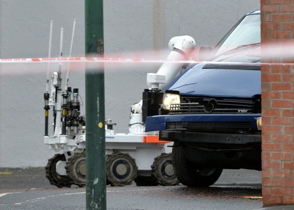 A bomb disposal robot next to the Adrian Ismay's van after the explosion had happened under the vehicle