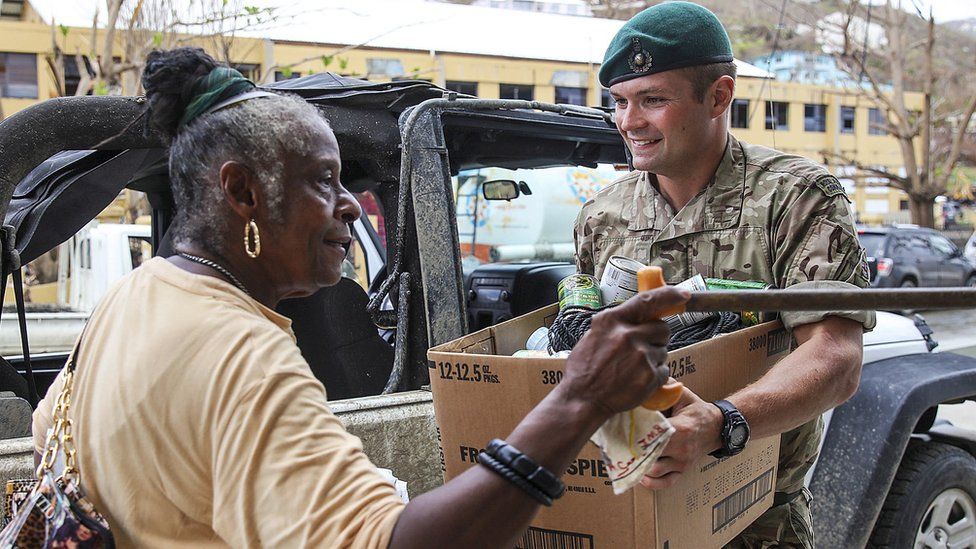 UK soldier giving citizen supplies before Hurricane Maria hits BVI