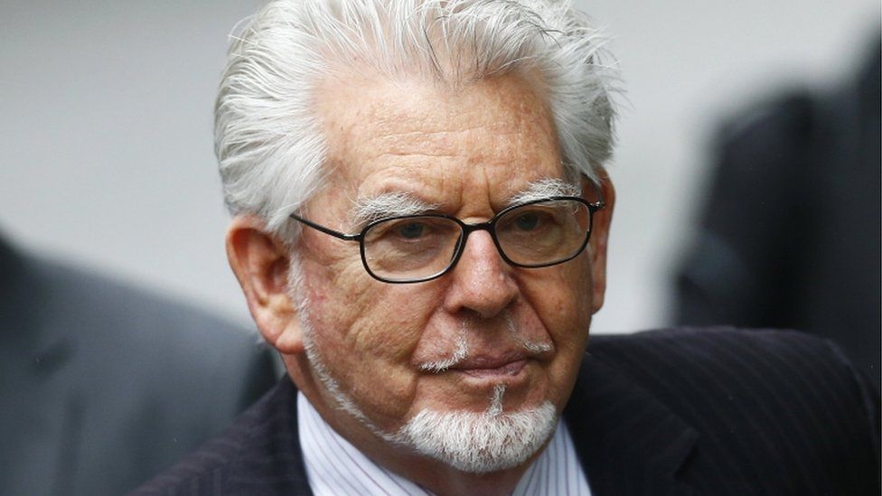 Rolf Harris to appear at trial via video link, judge rules BBC News