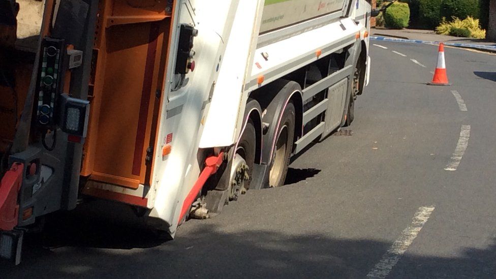 Bin lorry wheels in road