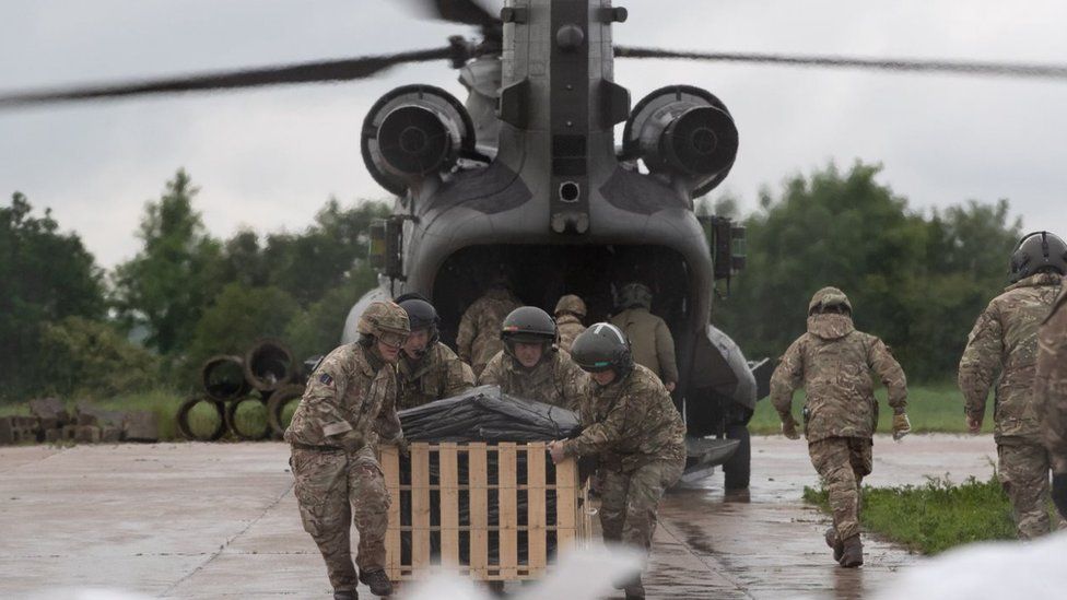 Crews loading the Chinook helicopter