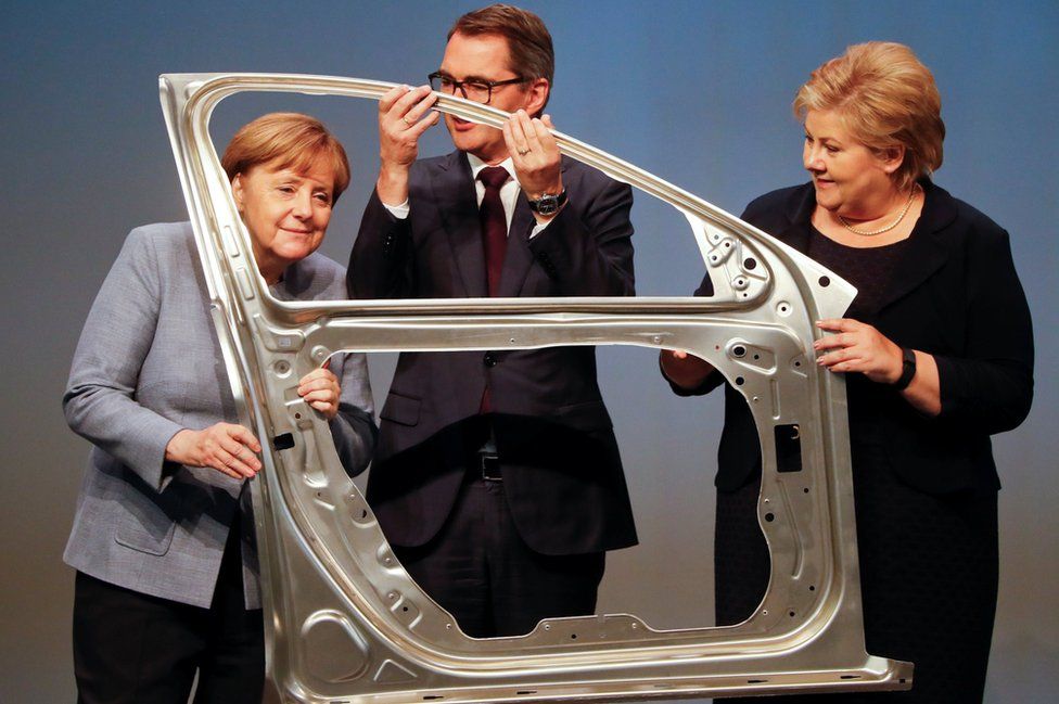 German Chancellor Angela Merkel, Svein Richard Brandtzaeg, President and Chief Executive Officer of Rolled Products and Norwegian Prime Minister Erna Solberg are seen during the official opening of a production line