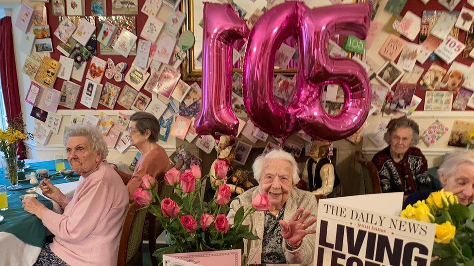 Bessie Poulson at her care home, surrounded by cards from well-wishers