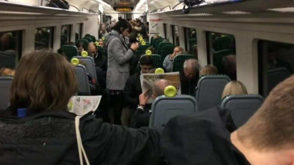 Passengers standing on a London Midland train