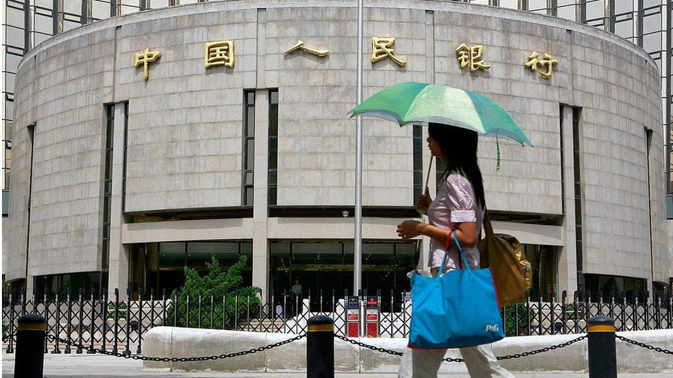 A pedestrian walks past the People's Bank of China