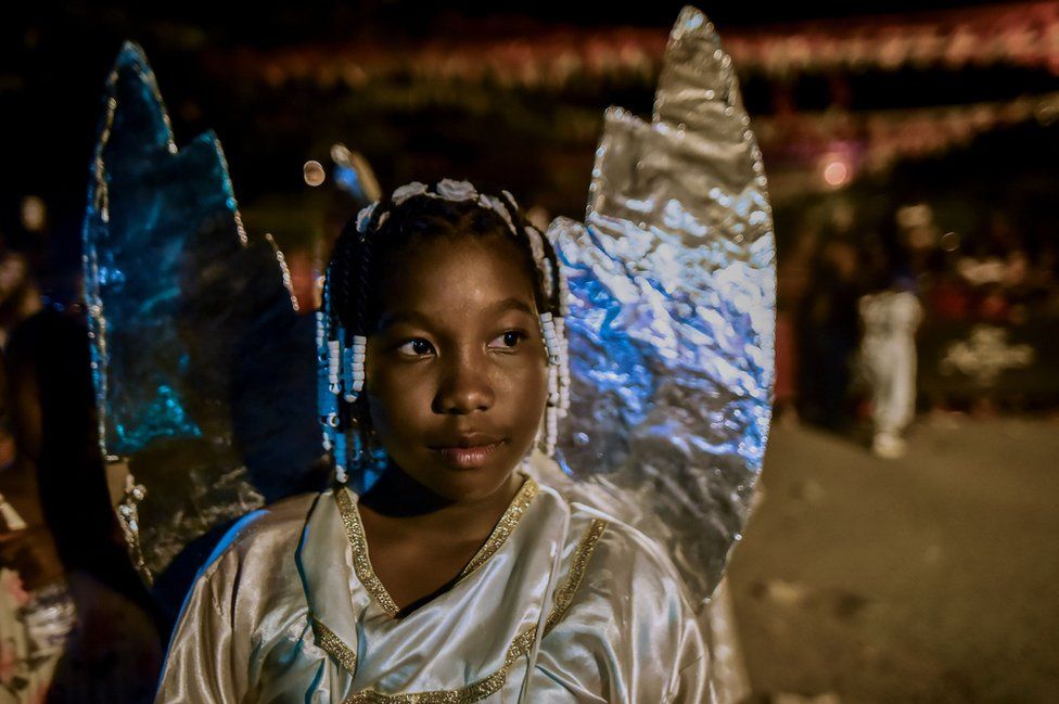 An Afro-Colombian girl in an angel costume takes part in the Adoraciones al Nino Dios celebrations.