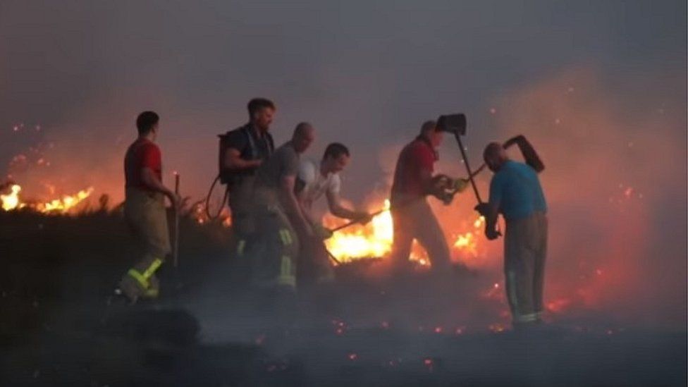 Firefighters try to quell the fire