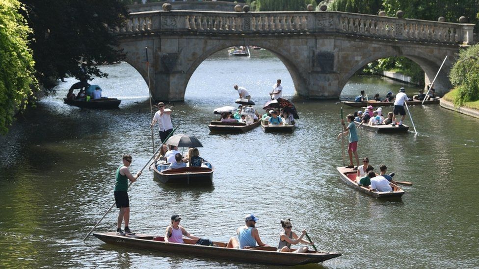 People punt along the River Cam in Cambridge