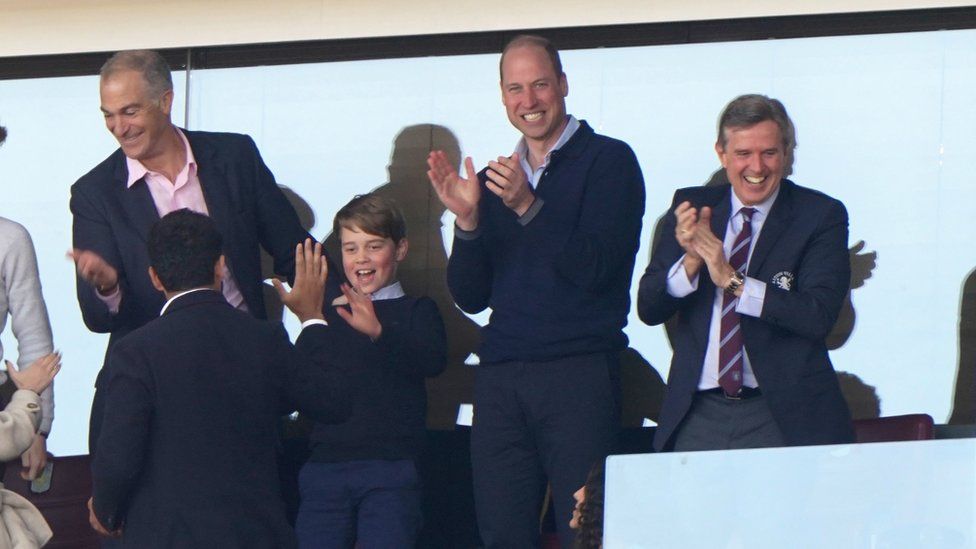The Prince of Wales with Prince George of Wales and Aston Villa chief executive Christian Purslow (right) celebrate their side's first goal