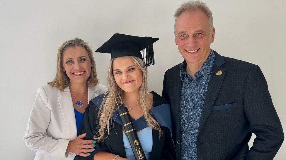 Gracie with her parents at her graduation