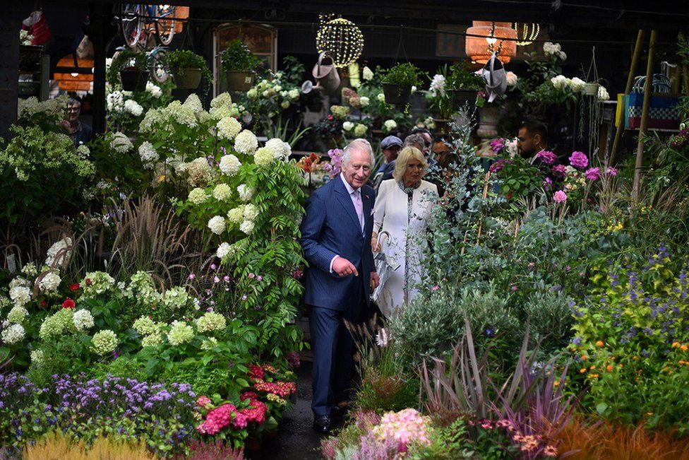 King Charles III and his wife Queen Camilla visit the central Paris Flower Market.