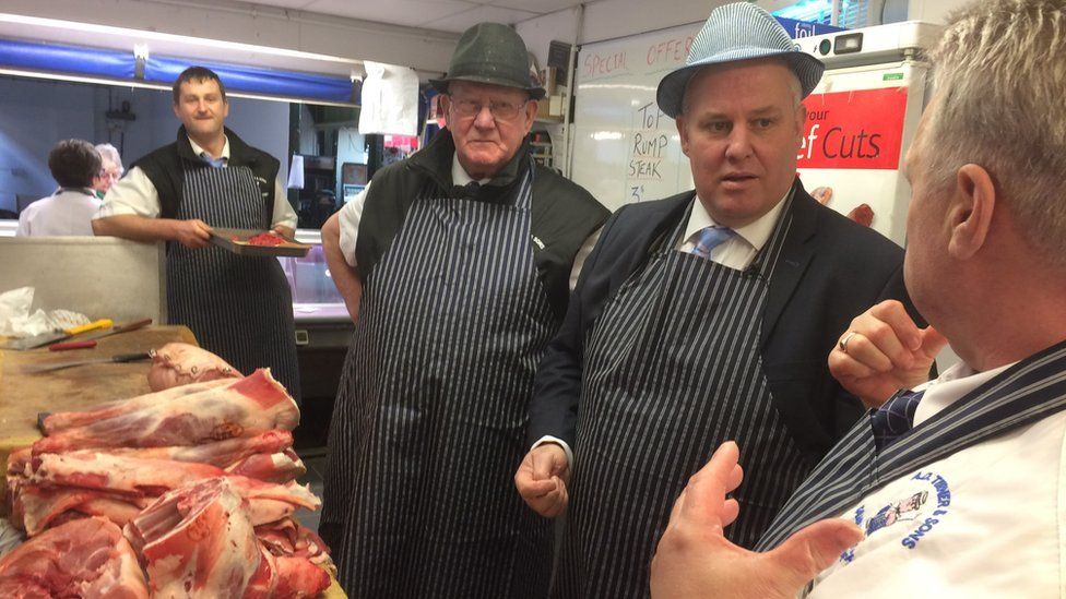 Andrew RT Davies at a butcher's shop