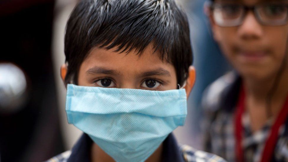 A school child in India wearing a mask