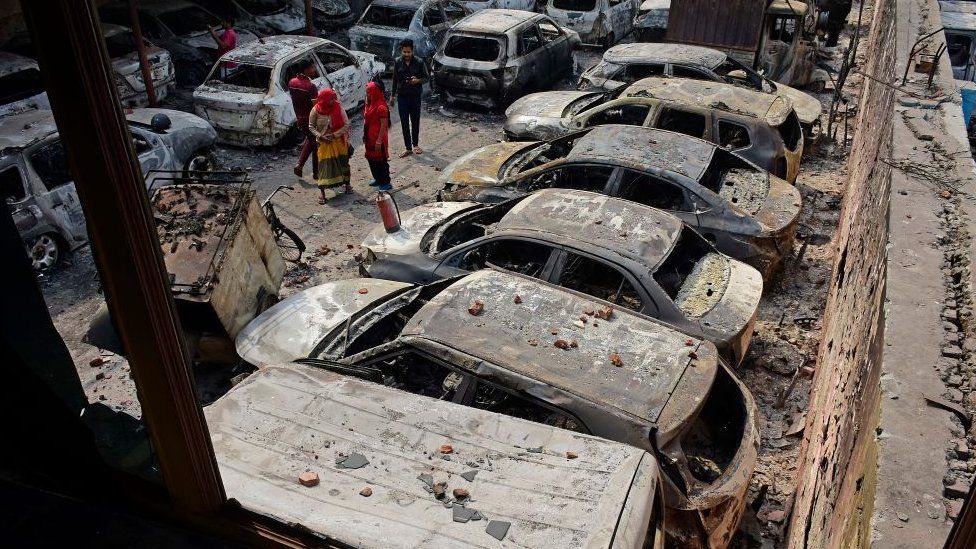 Residents try to identify their charred vehicles in a car parking area which was set ablaze in a recent violence in Mustafa Abad area in New Delhi February 29, 2020.