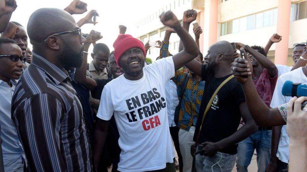 Supporters celebrate in a street of Dakar after the courthouse has decided to release activist Kemi Seba from the Rebeuss jailhouse on August 29, 2017. Kemi Seba was arrested after he burned a 5,000 CFA franc bank note during a meeting on August 19, 2017