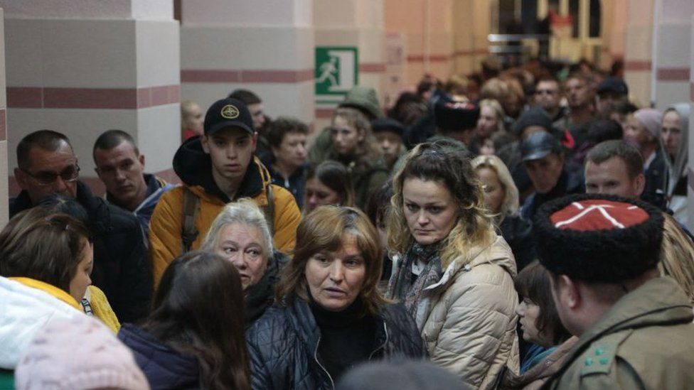 A crowd of people in a train station