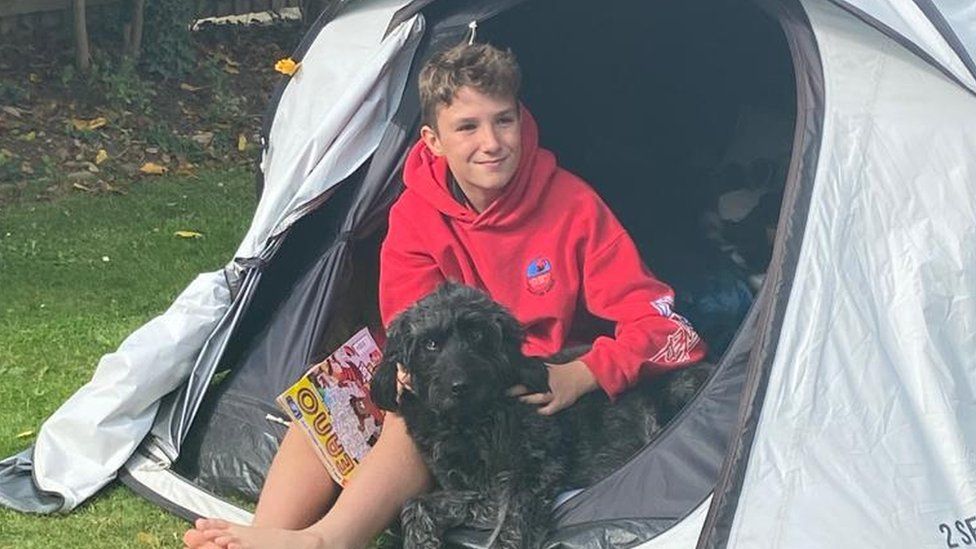 Max sleeping in tent with dog