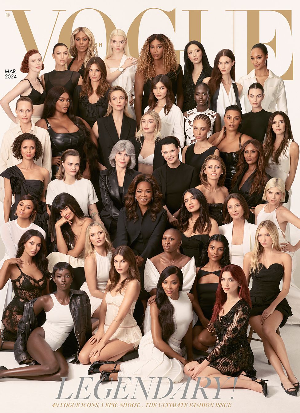 Forty women of varying ages and ethnicities gathered before a white studio backdrop. All are dressed in black, white or a combination of the two, and are looking into the camera. The four women at the front are sitting on the floor, and the rest are behind, arranged in rows that increase in height, so that all 40 are visible. Above their heads, the Vogue logo in gold letters. The cover line reads: "Legendary! 40 Vogue icons, one epic shoot... the ultimate fashion issue."