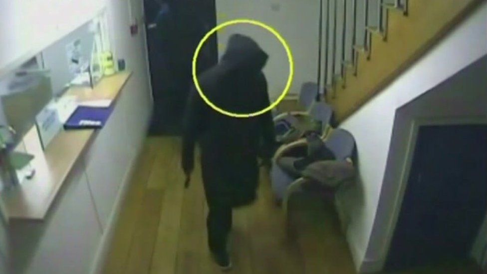 The robbers entering the building