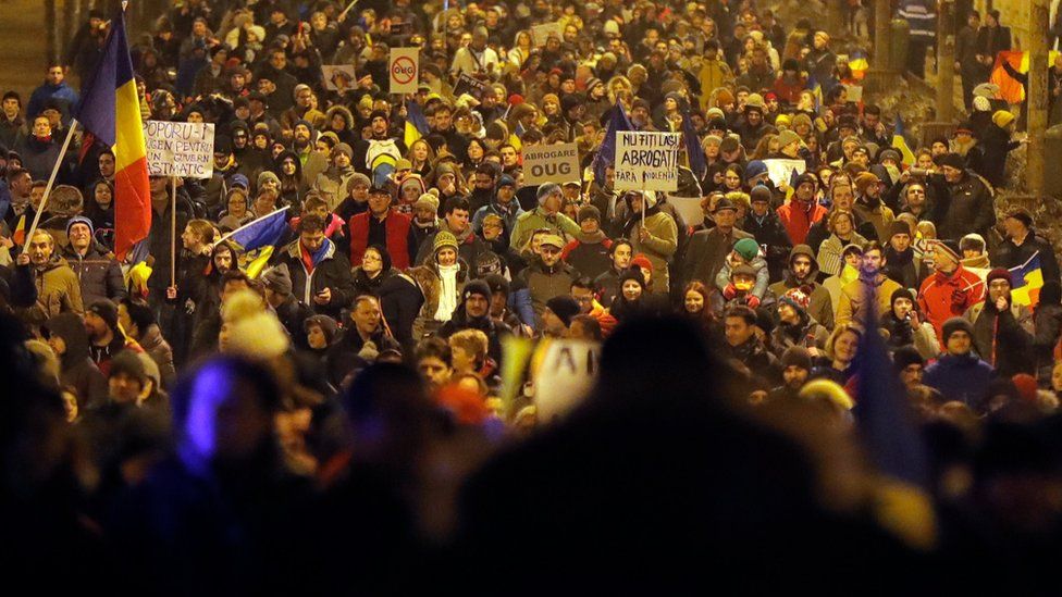 Demonstrators march in front of the government building during a protest in Bucharest, Romania, Saturday, Feb. 4, 2017