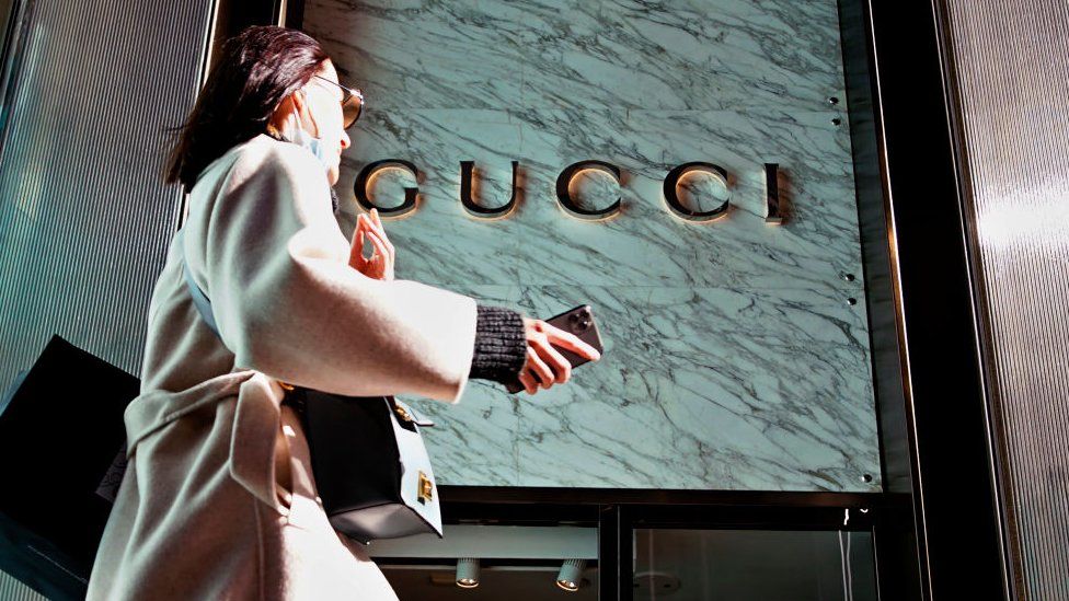 A woman walks in front of the Gucci store on Fifth Avenue in Trump Tower.
