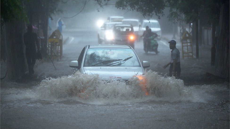 Vehicles wade through a Waterlogged stretch under a railway bridge near Sarojini Nagar during monsoon rain on July 9, 2023 in New Delhi, India.