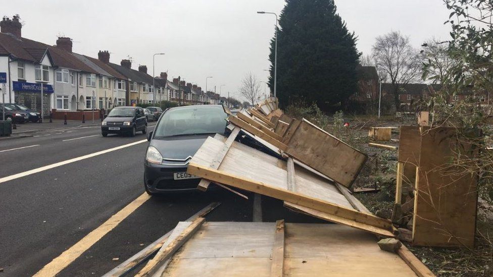 Fence blown down on a car in Cardiff