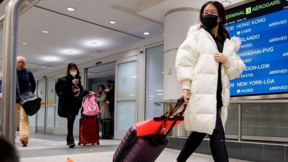 Travellers are seen wearing masks at the international arrivals area at the Toronto Pearson Airport in Toronto, Canada, January 26, 2020