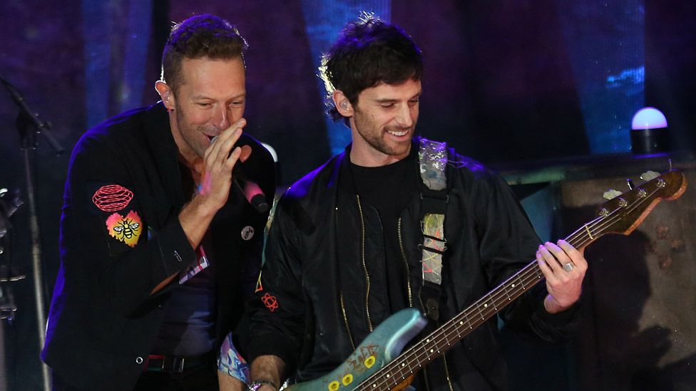 UK band Coldplay look in lively spirits as they stand outside BBC