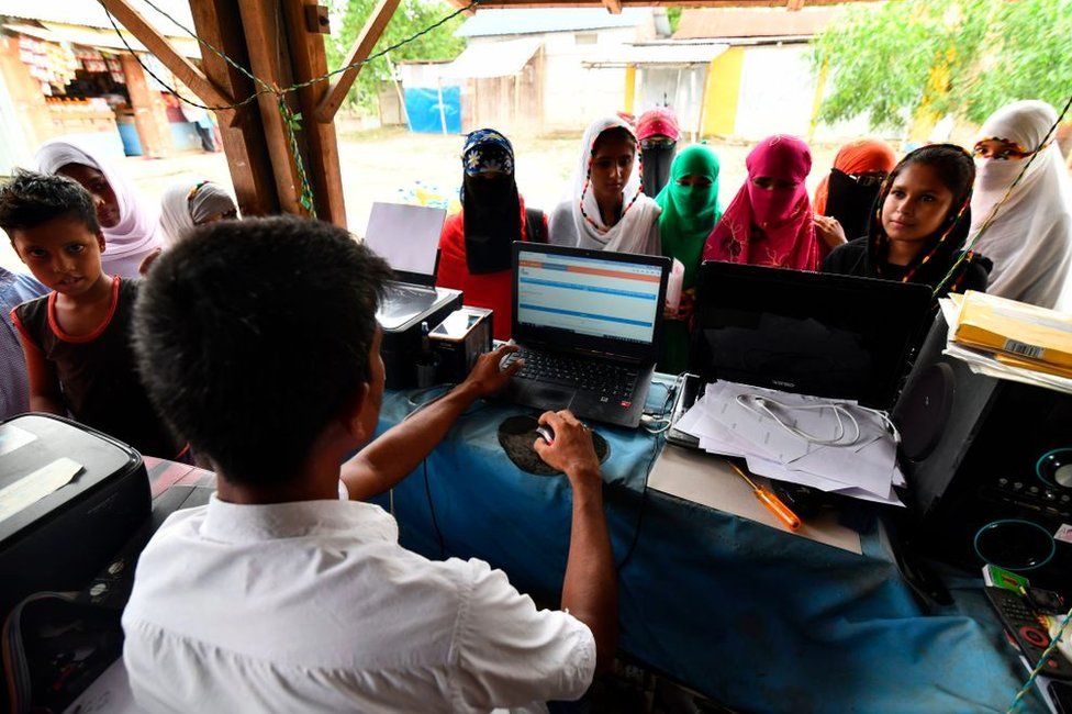 Muslim women check their names on the final list of the NRC in Assam 31 August 2019
