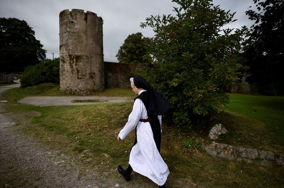 Sister Marie Fahy walks through the farm in St Mary's Abbey