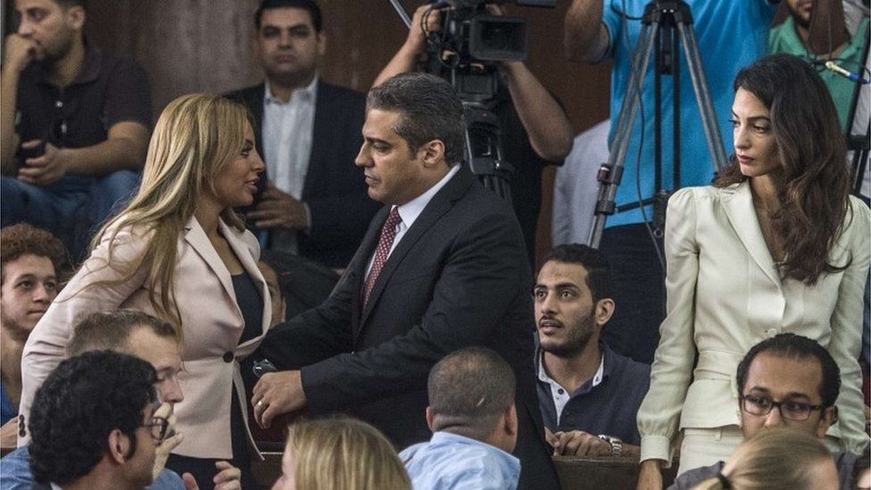 Canadian al-Jazeera journalist Mohamed Fahmy with his wife Marwa, while his lawyer Amal Clooney looks on, 29 August 2015