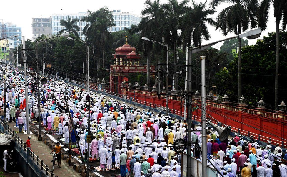 Muslims walk down a street as part of a special prayer